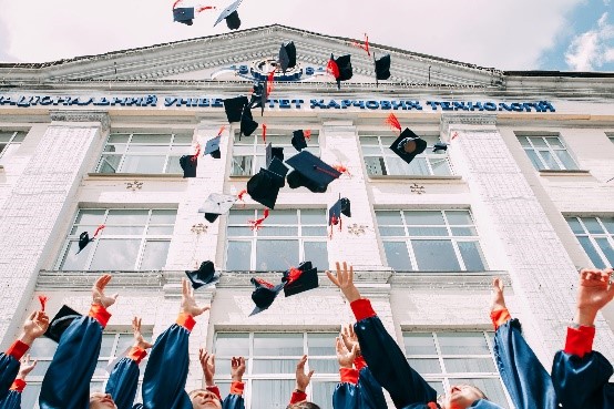 Graduation hats being thrown in the air